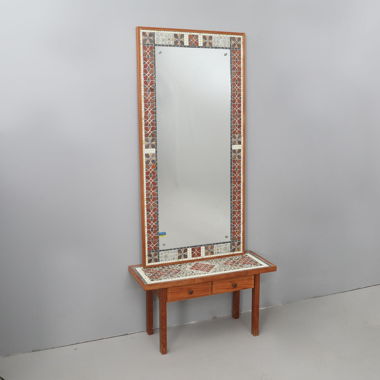 A 1960's teak/mosaic table mirror.