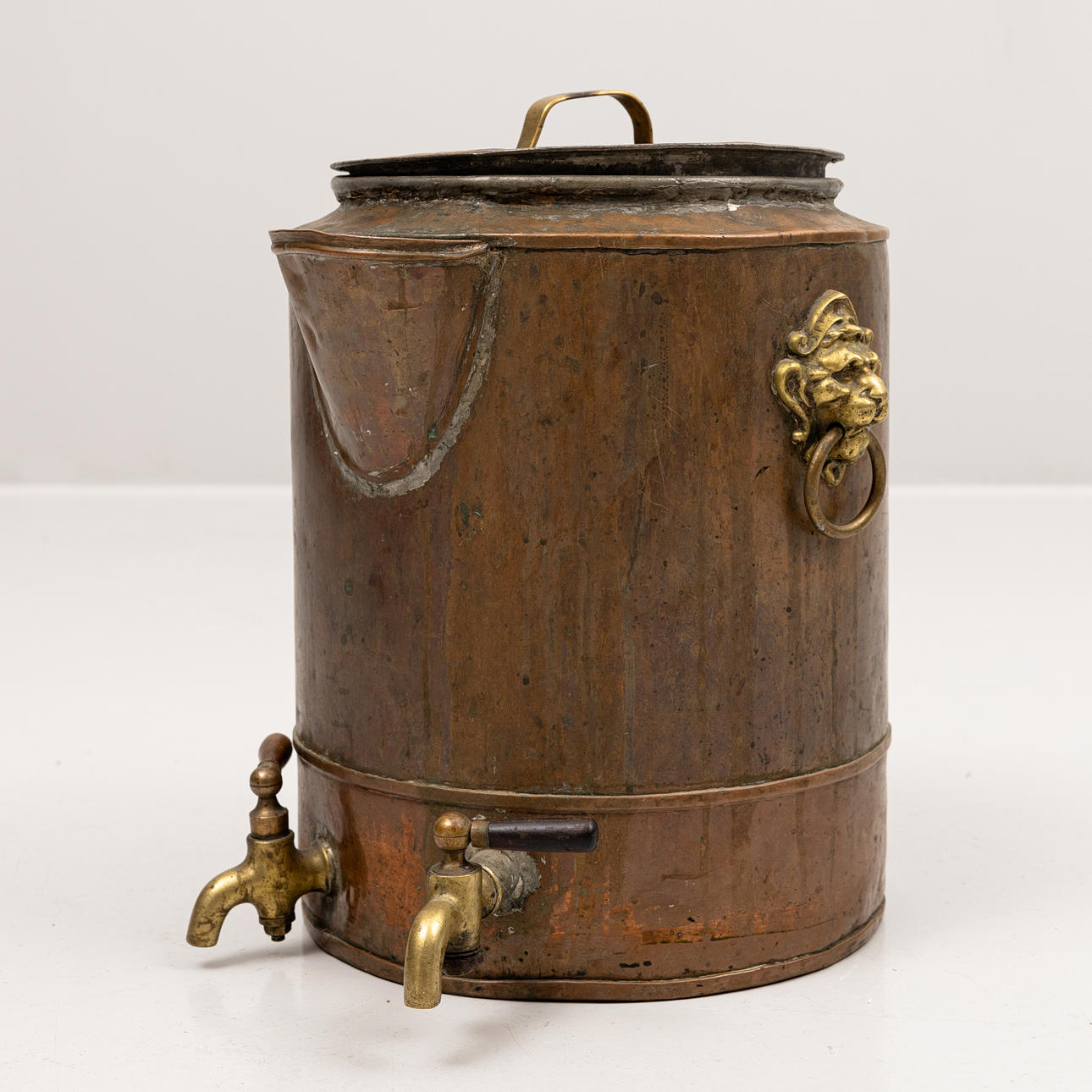 A 19th century copper water tank with taps.
