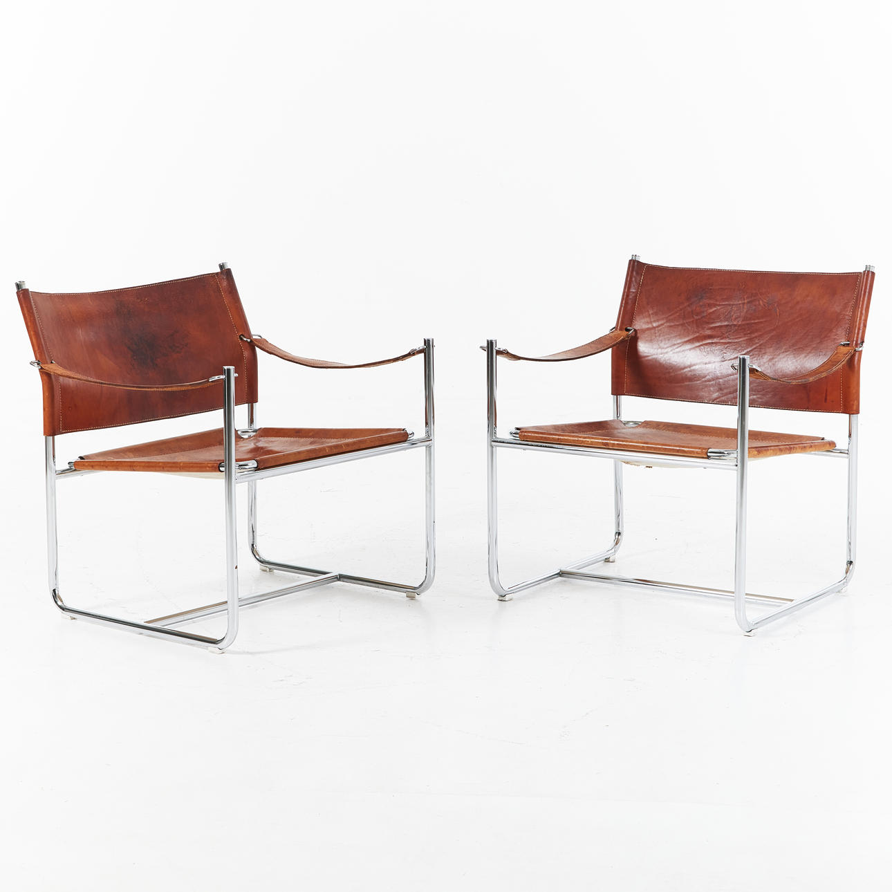 KARIN MOBRING. "Amiral", fåtöljer, 1 par, IKEA,1970-tal, kromad ställning med naturfärgad läderklädsel.