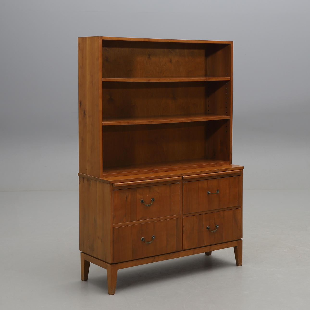 A mid 20th century fruit wood bookcase.