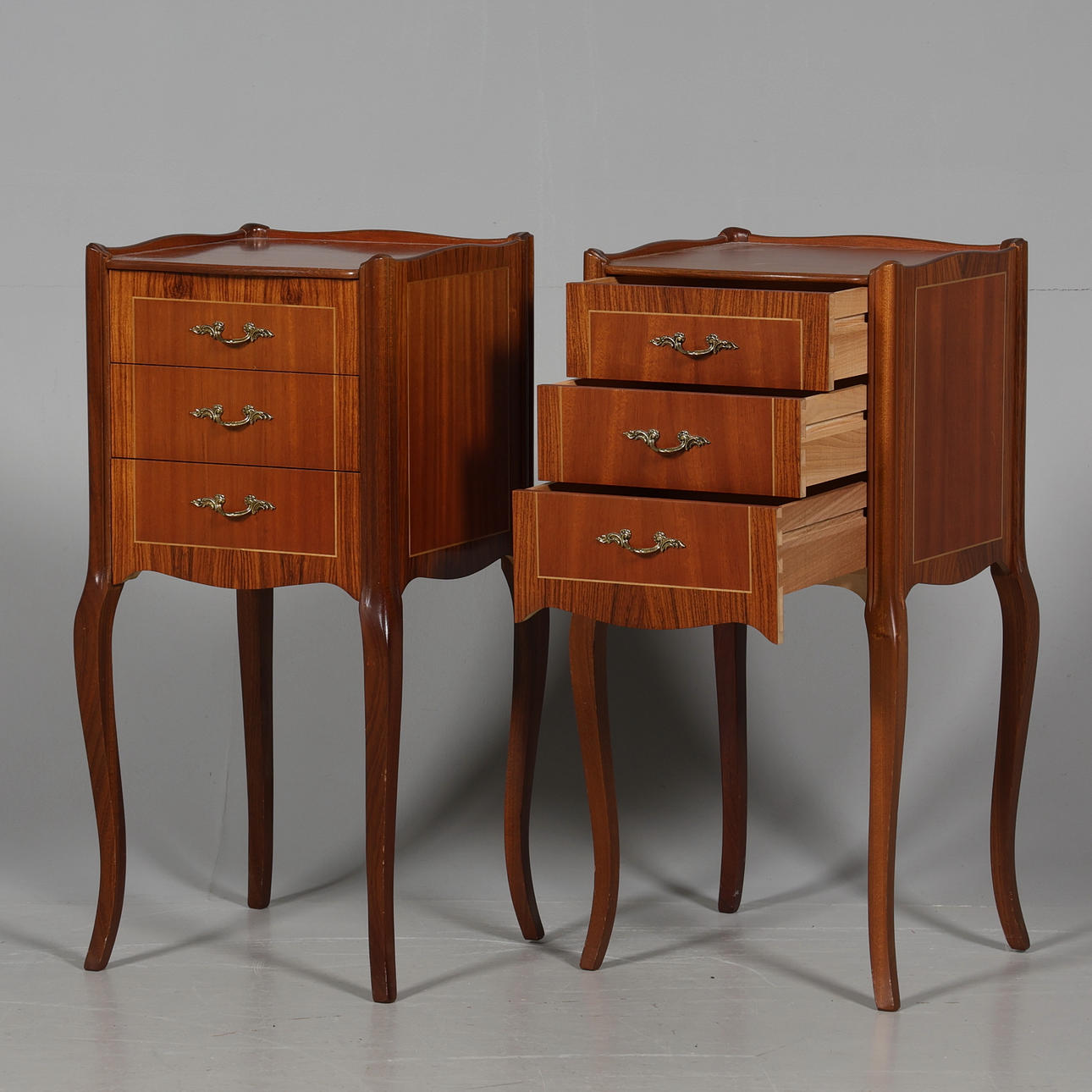 A pair of rococo style bedside tables, 20th century.