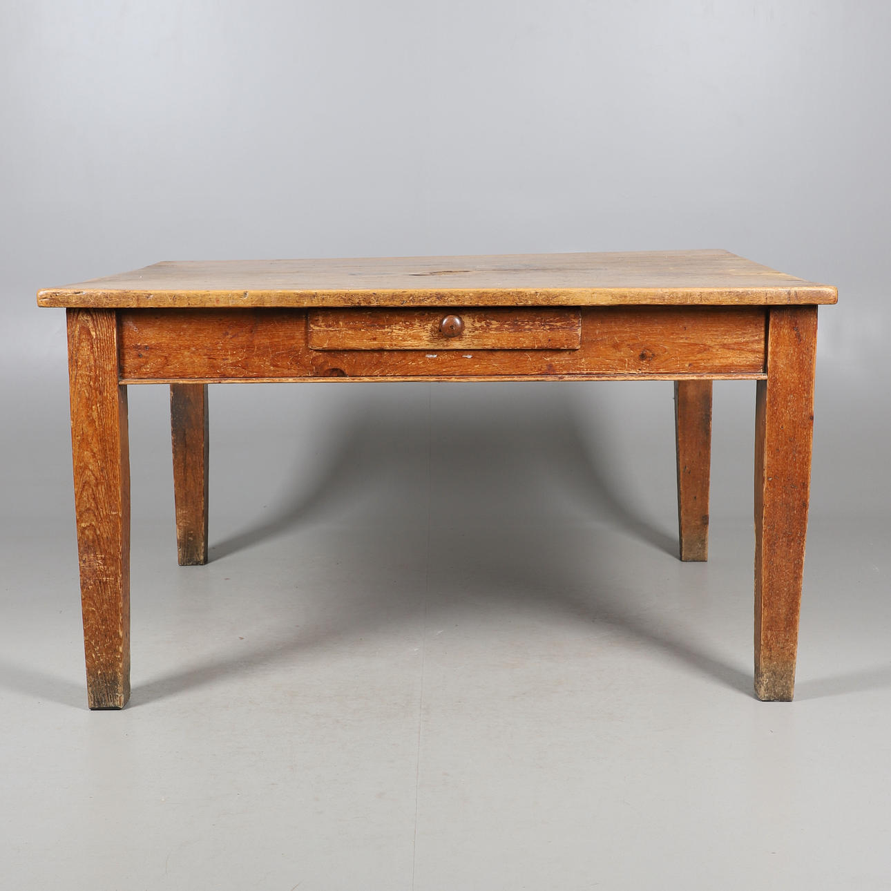 A 19TH CENTURY PINE SQUARE KITCHEN TABLE.
