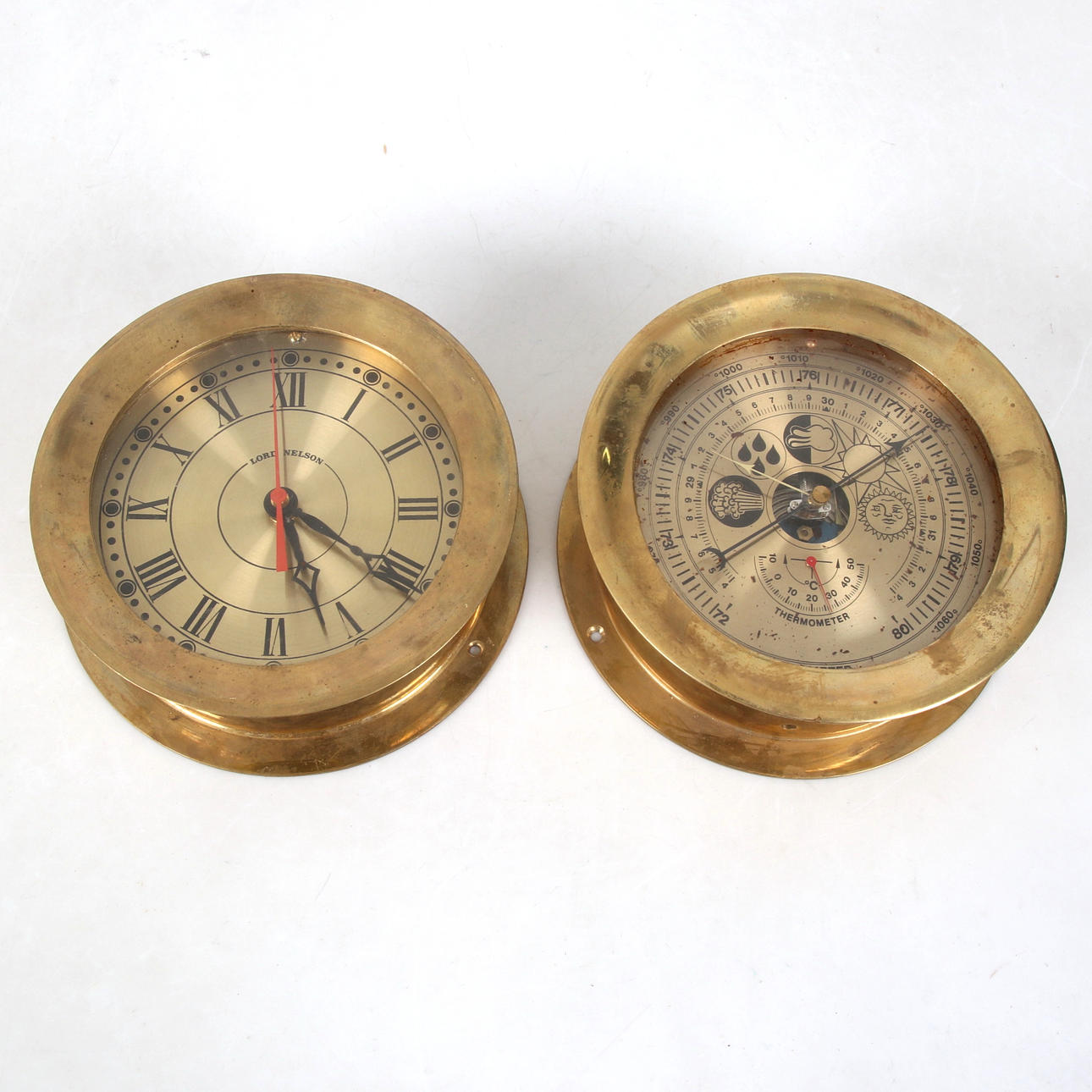 A brass ship clock and barometer, including Lord Nelson.