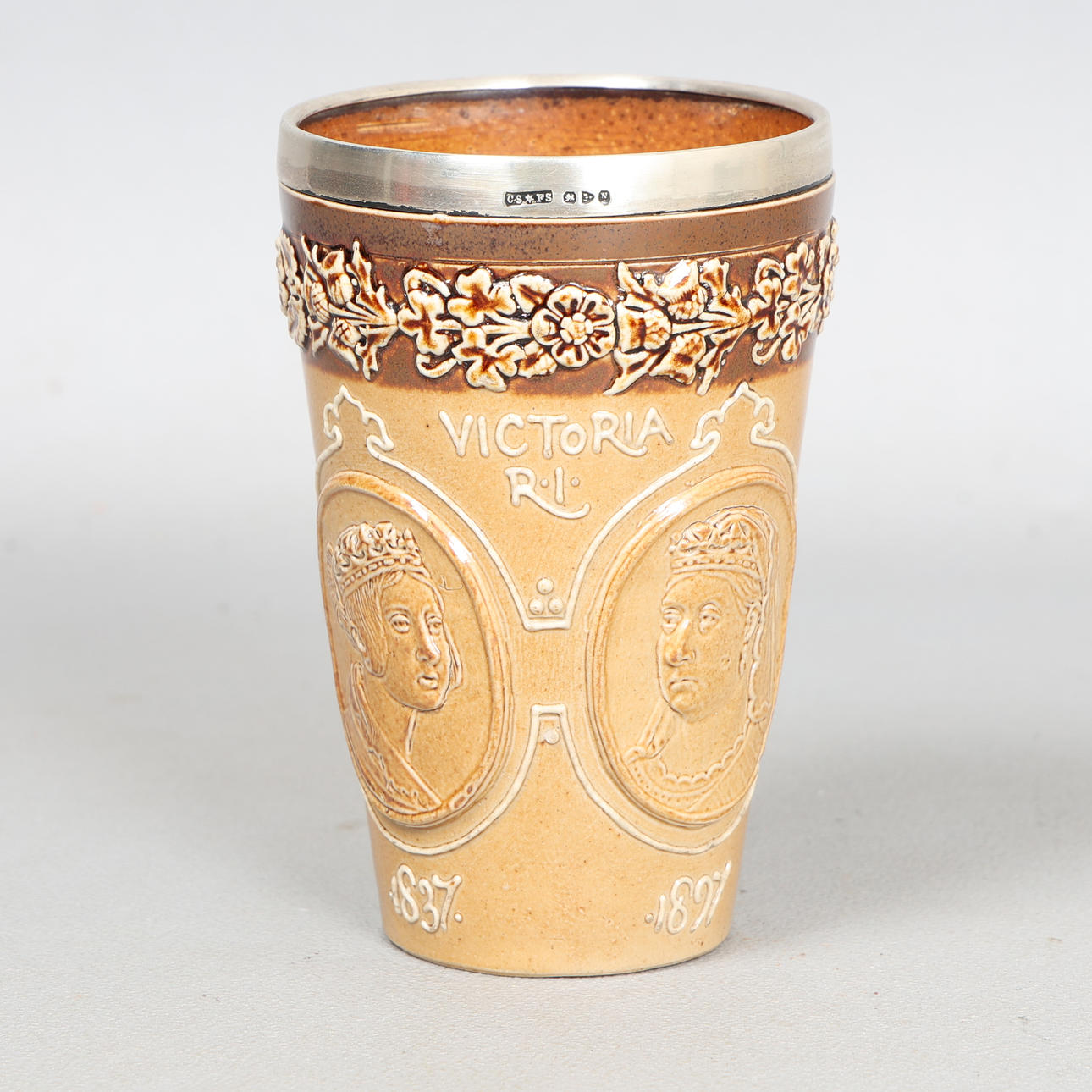 A DOULTON LAMBETH STONEWARE BEAKER.