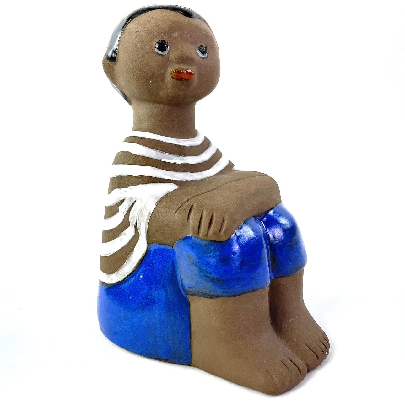 MARI SIMMULSON. A ceramic figure, seated boy, Upsala Ekeby. Monogram Signed.