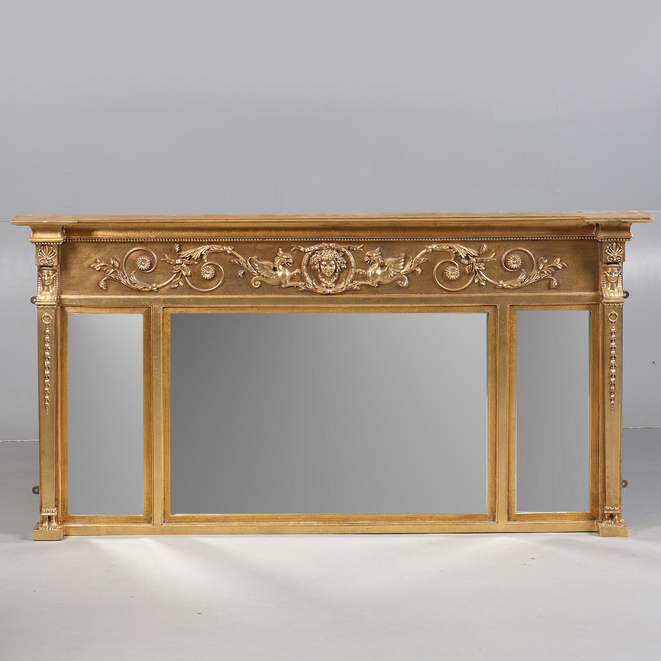 A REPRODUCTION REGENCY STYLE GILT COMPOSITION TRIPLE PLATE OVERMANTEL.