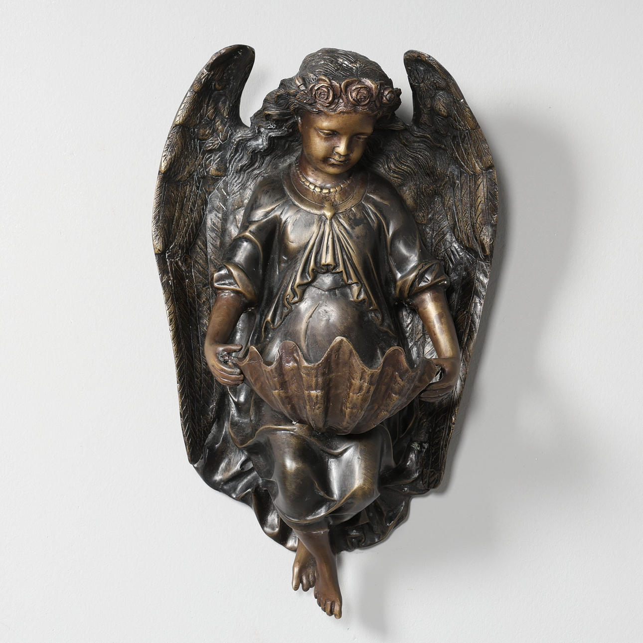 A BRONZE ANGEL WALL SCULPTURE.