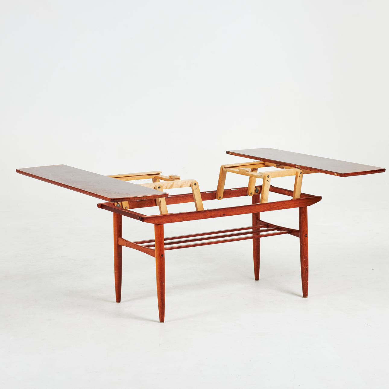 A 1960's teak coffee table with newspaper shelf.