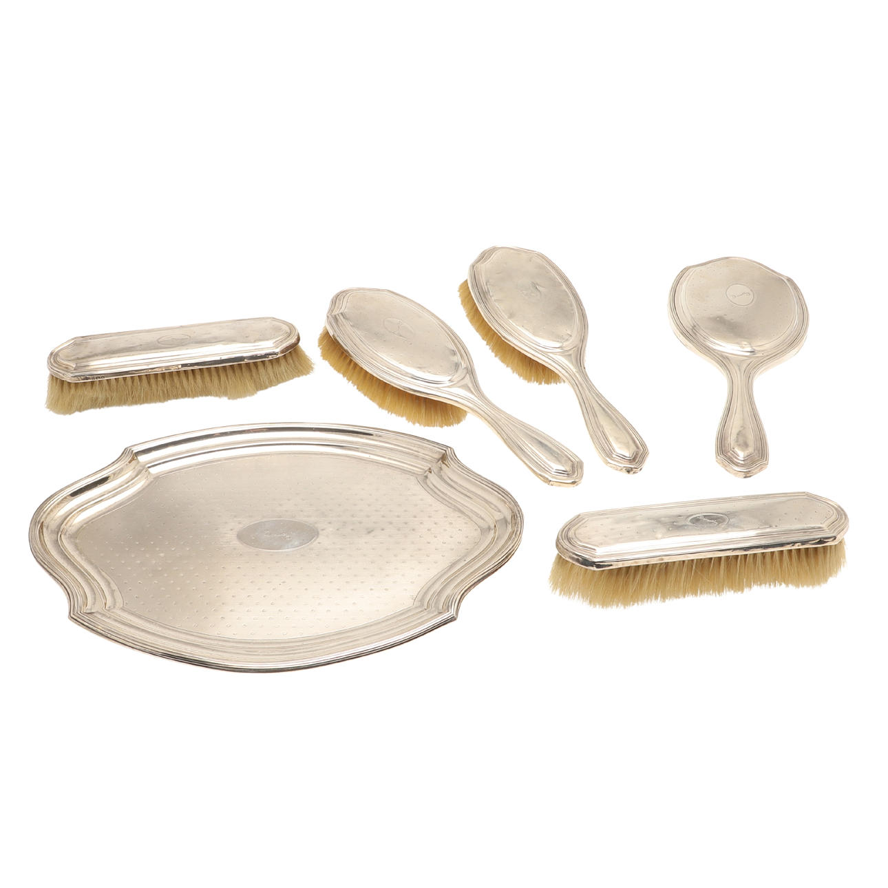 A GEORGE V FIVE PIECE SILVER BACKED DRESSING TABLE SET.