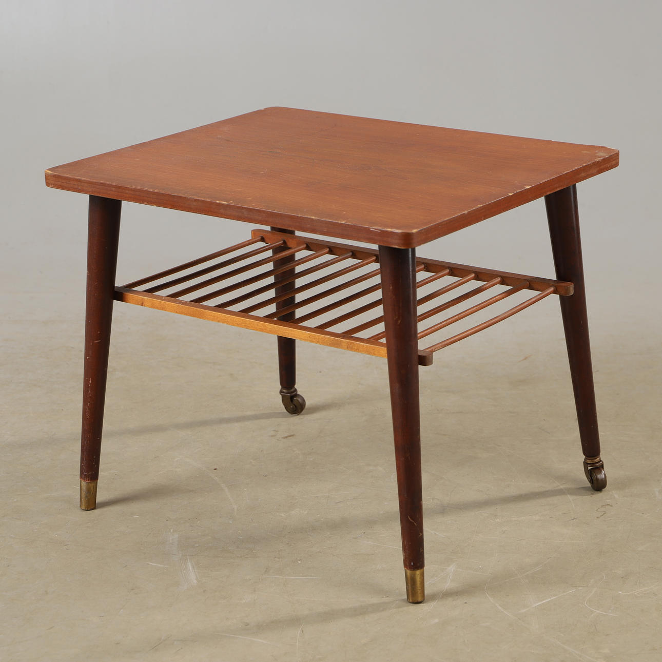 TABLE WITH SHELF, teak with brass finish, mid 20th century.