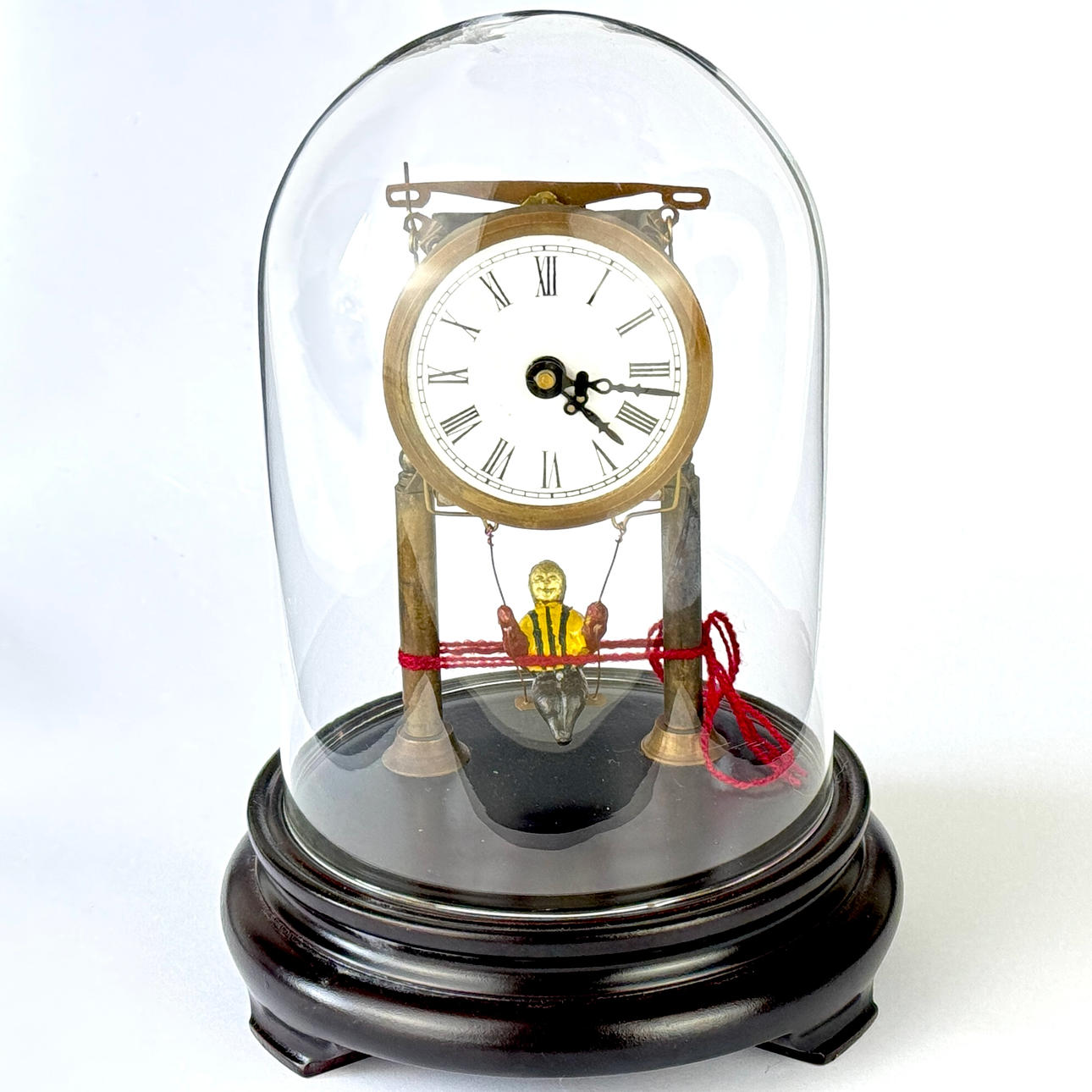 SKELETON CLOCK UNDER DOME.