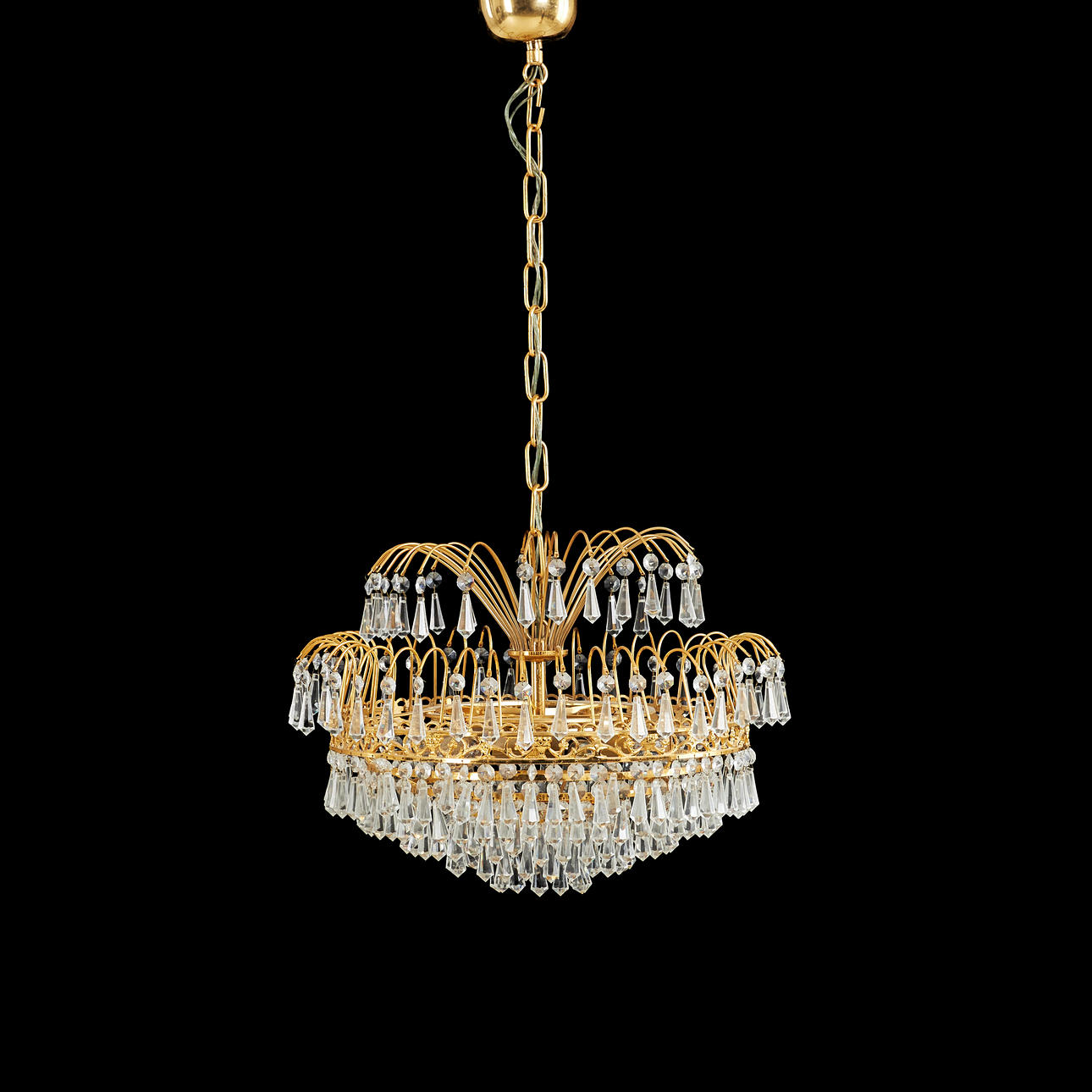 A 20th century chandelier, brass frame, hung with prisms, 6 light sources.