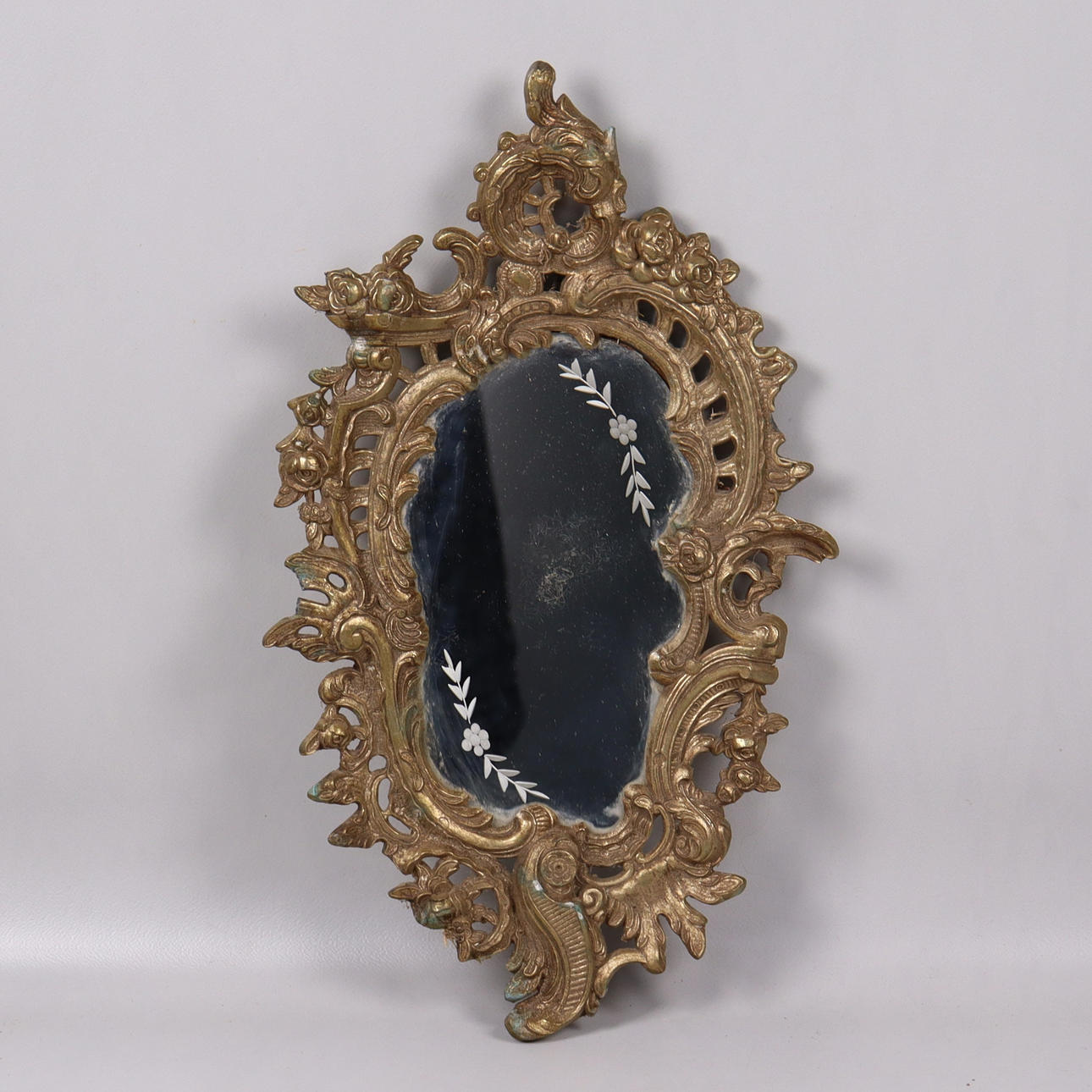 A metal rococo mirror, 20th century.