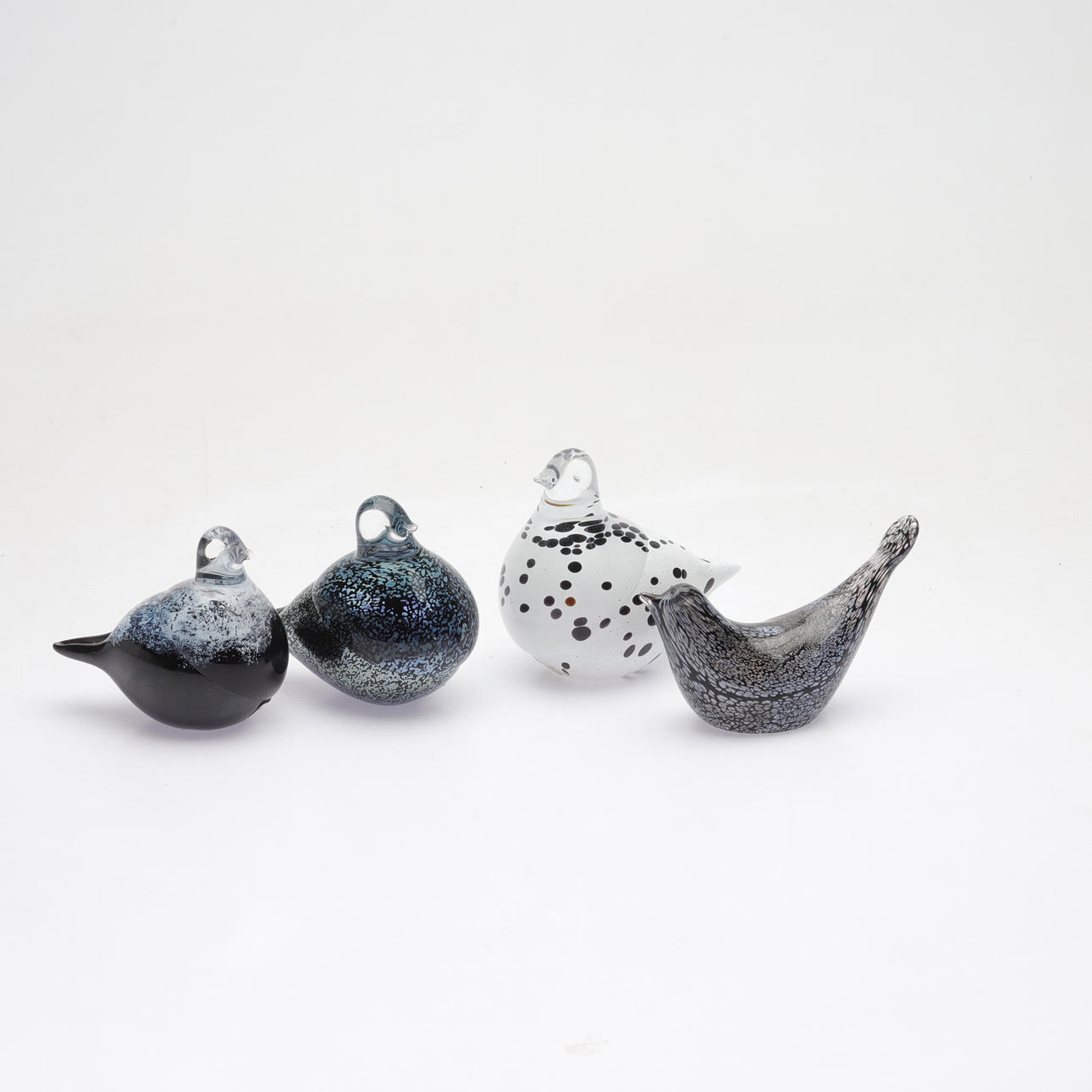 A set of 4 glass figurines, including Haparanda.