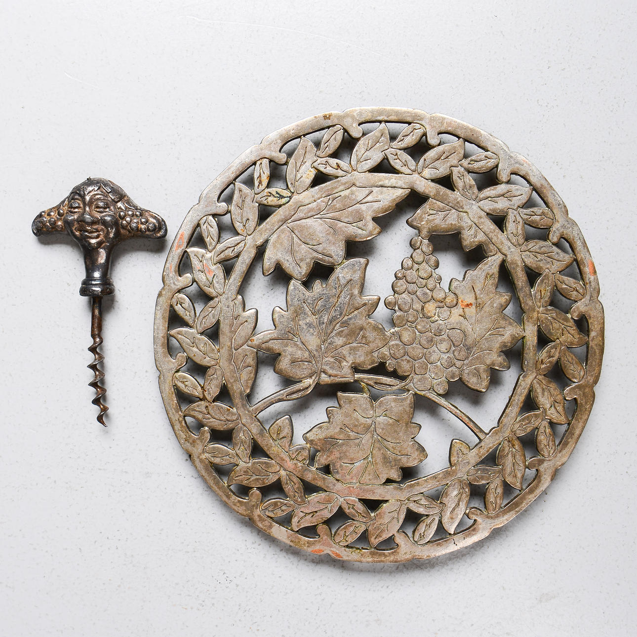 A Bacchus & Vine Pot Coaster and Corkscrew, later 20th century.