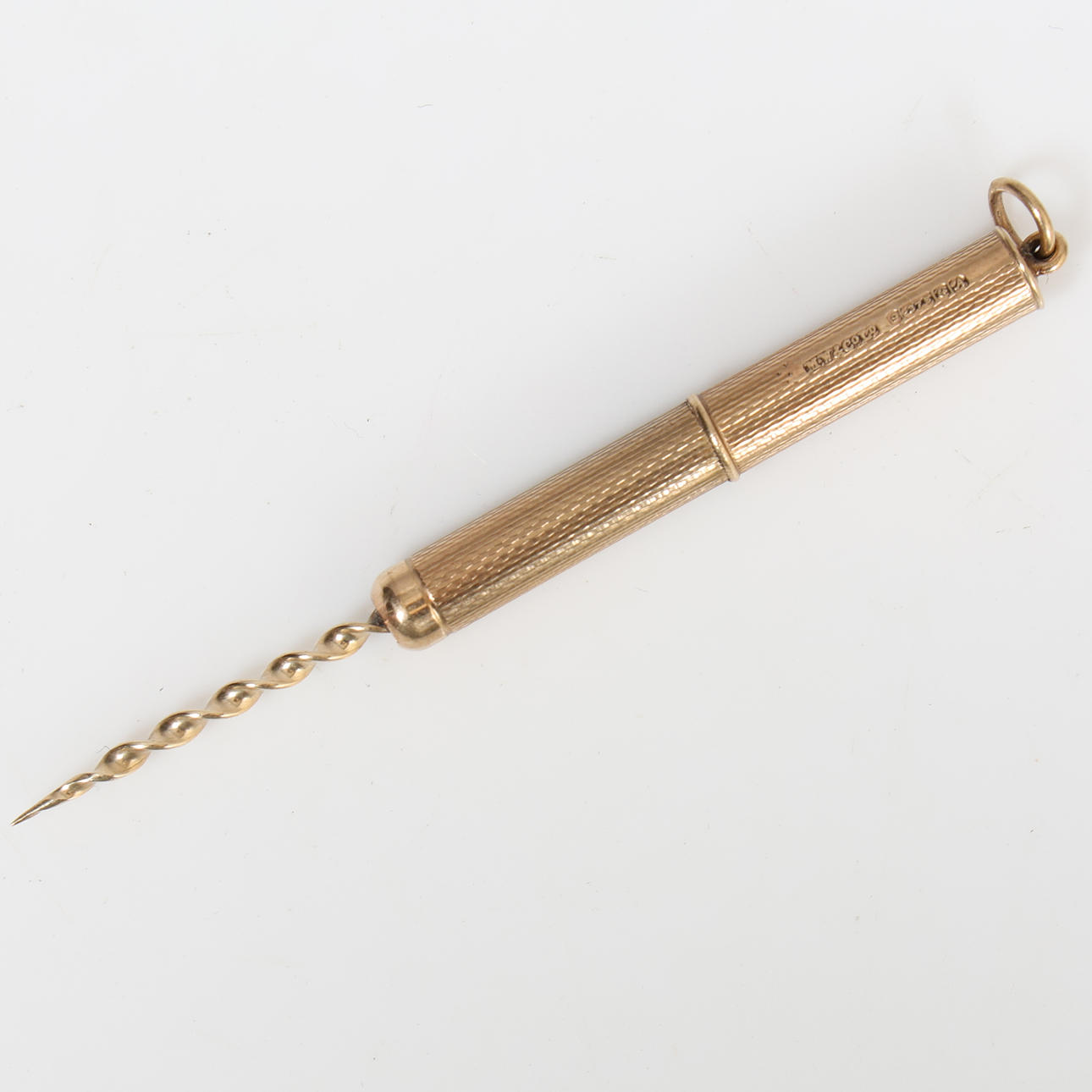 A 9 CARAT GOLD TOOTH PICK.