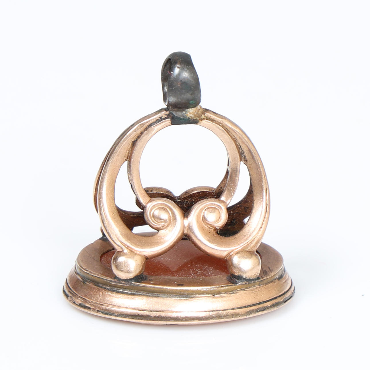 A YELLOW METAL FOB SEAL.