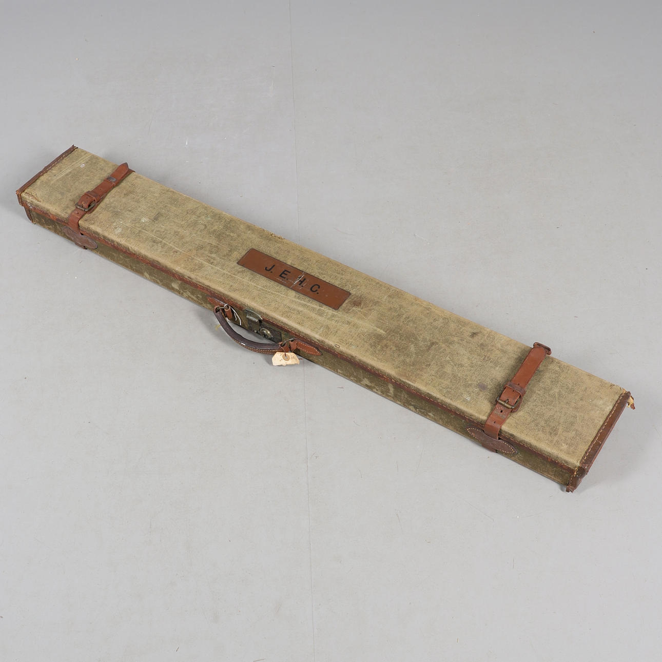 A CANVAS AND LEATHER SHOTGUN CASE.
