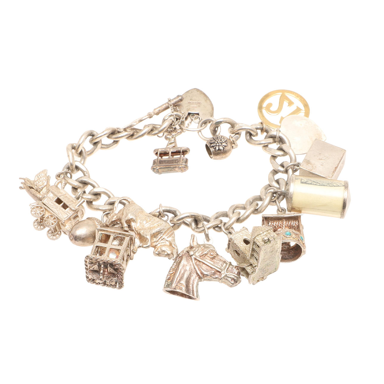 A SILVER BRACELET AND ATTACHED CHARMS.