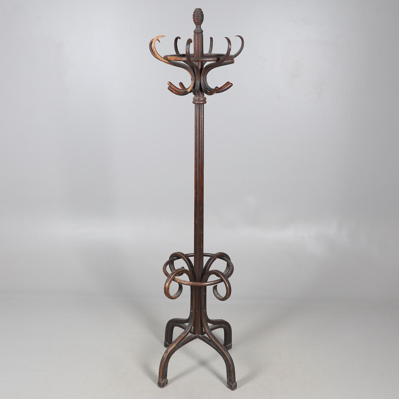 A STAINED BENTWOOD COAT/HAT STAND.