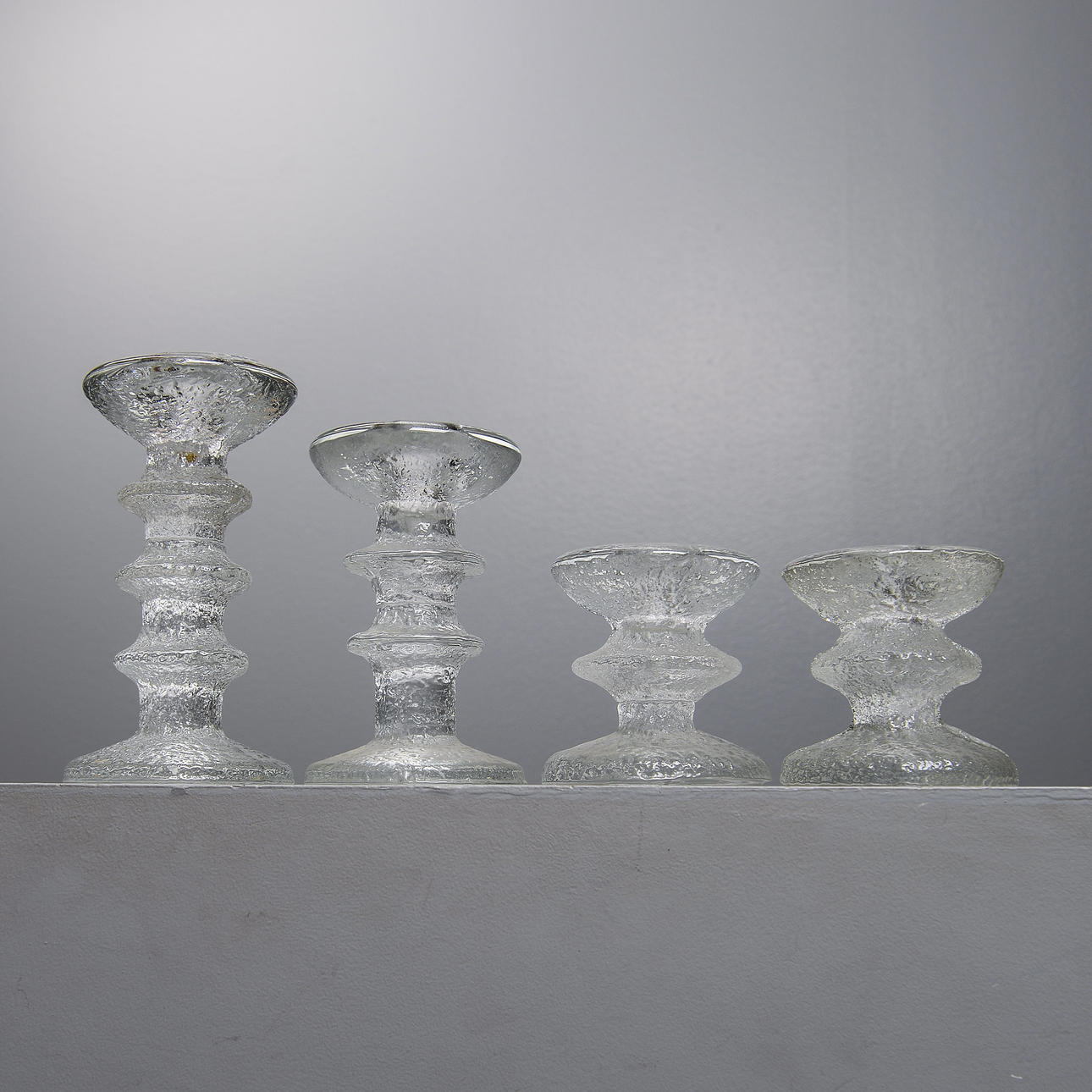 TIMO SARPANEVA. “Festivo”, 4 candlesticks, Iittala, mostly signed.