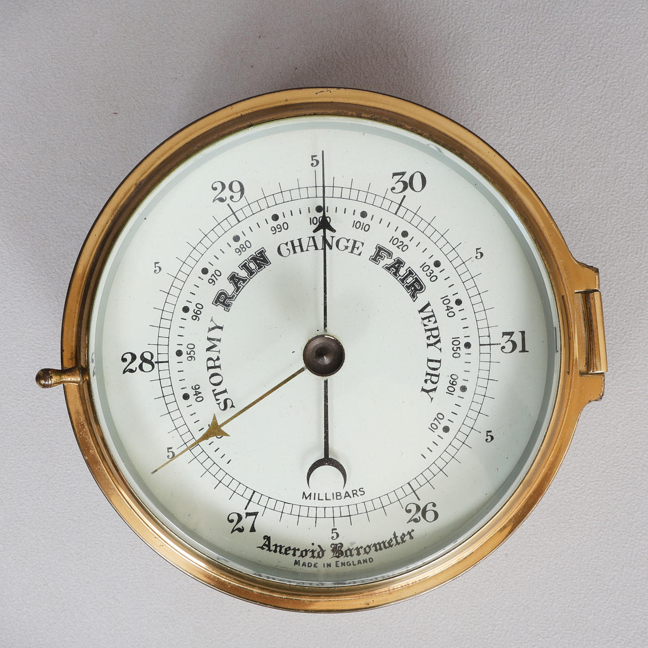 A MILLIBARS SHIPS BULKHEAD ANEROID BAROMETER.