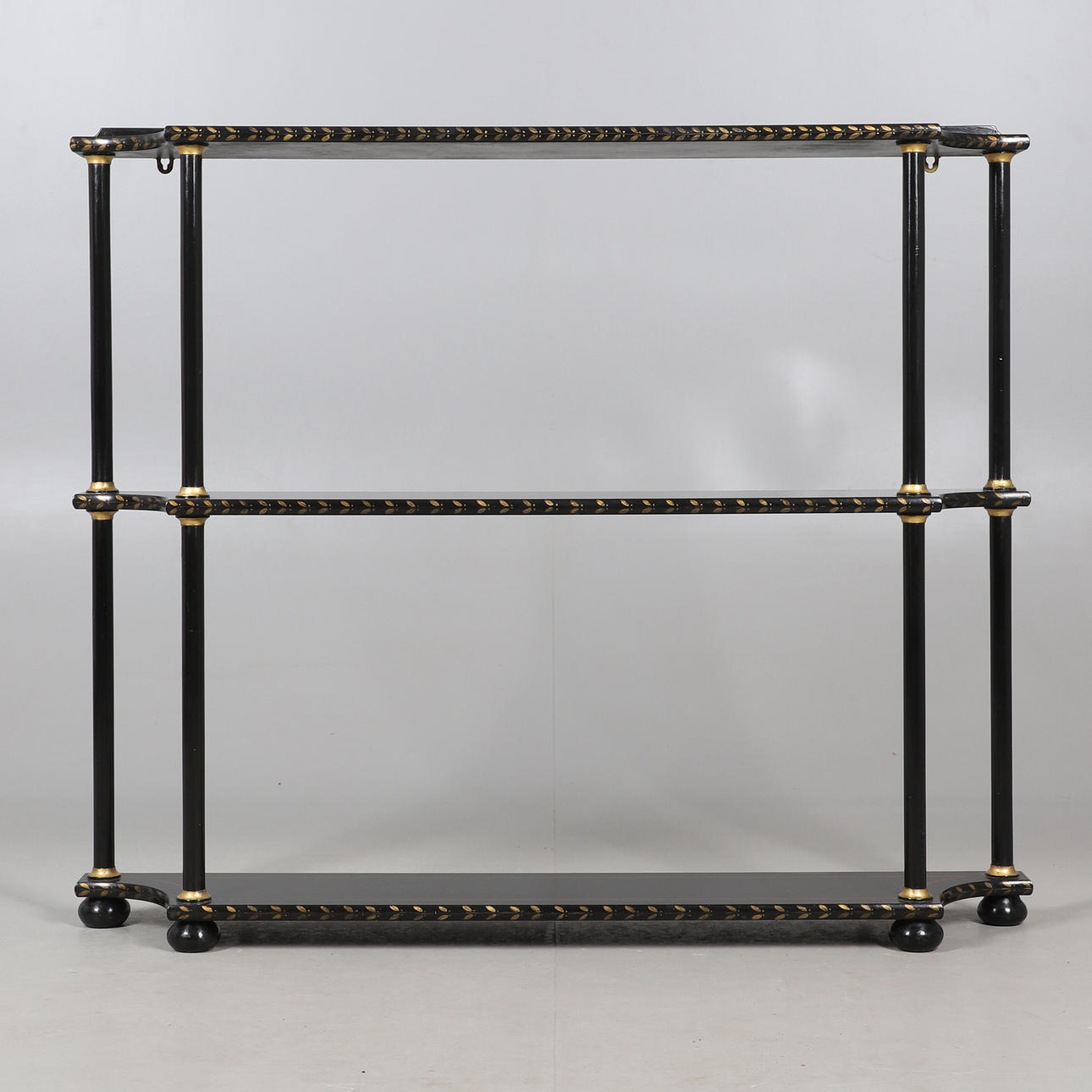 A THREE TIER PAINTED FLOOR STANDING SHELVES.