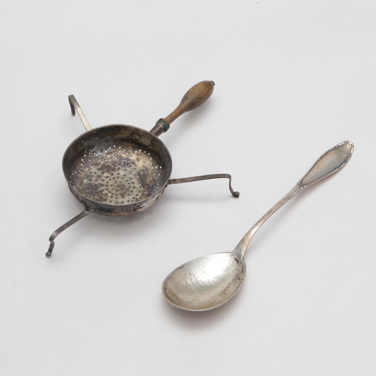 A silver tea spindle and spoon.