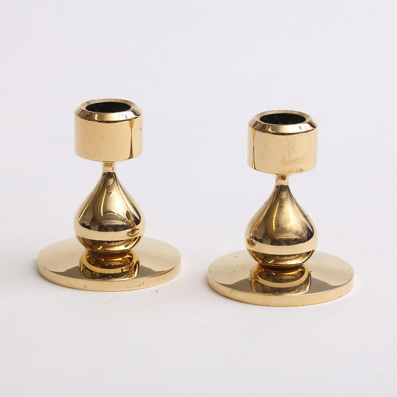 A pair of gold-plated candlesticks, Design Asmussen, Denmark.