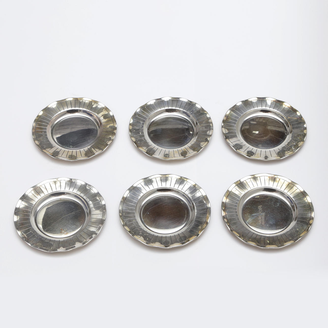 A set of 6 coasters, silver.