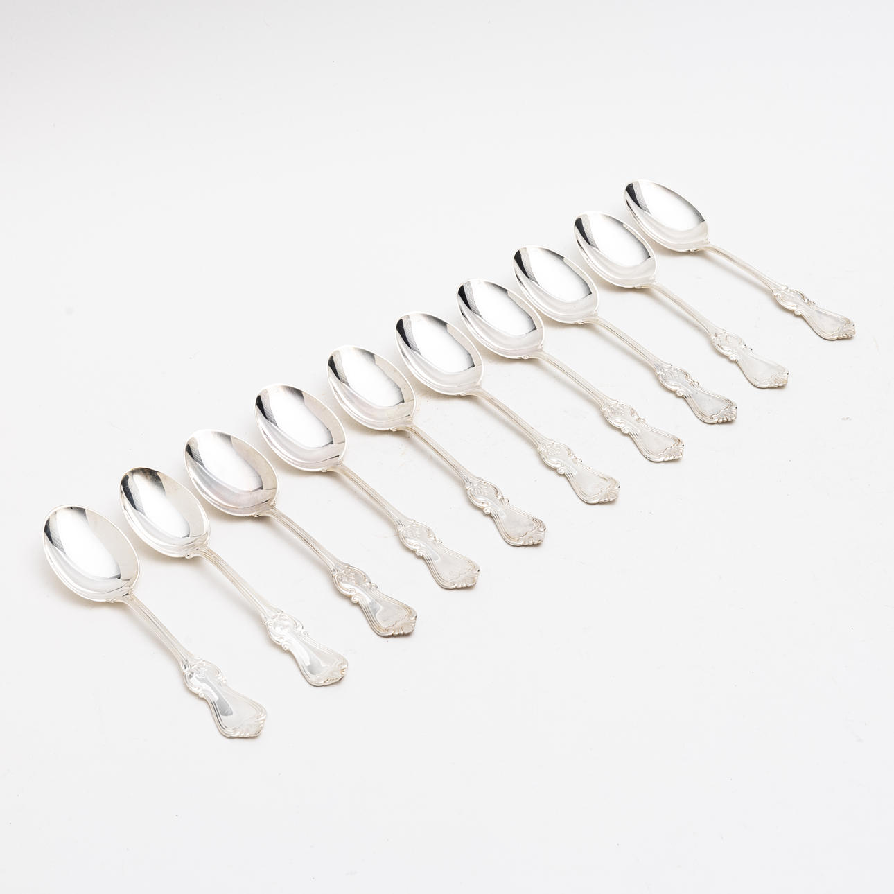 A set of 10 silver dessert spoons, 1990-2000's.