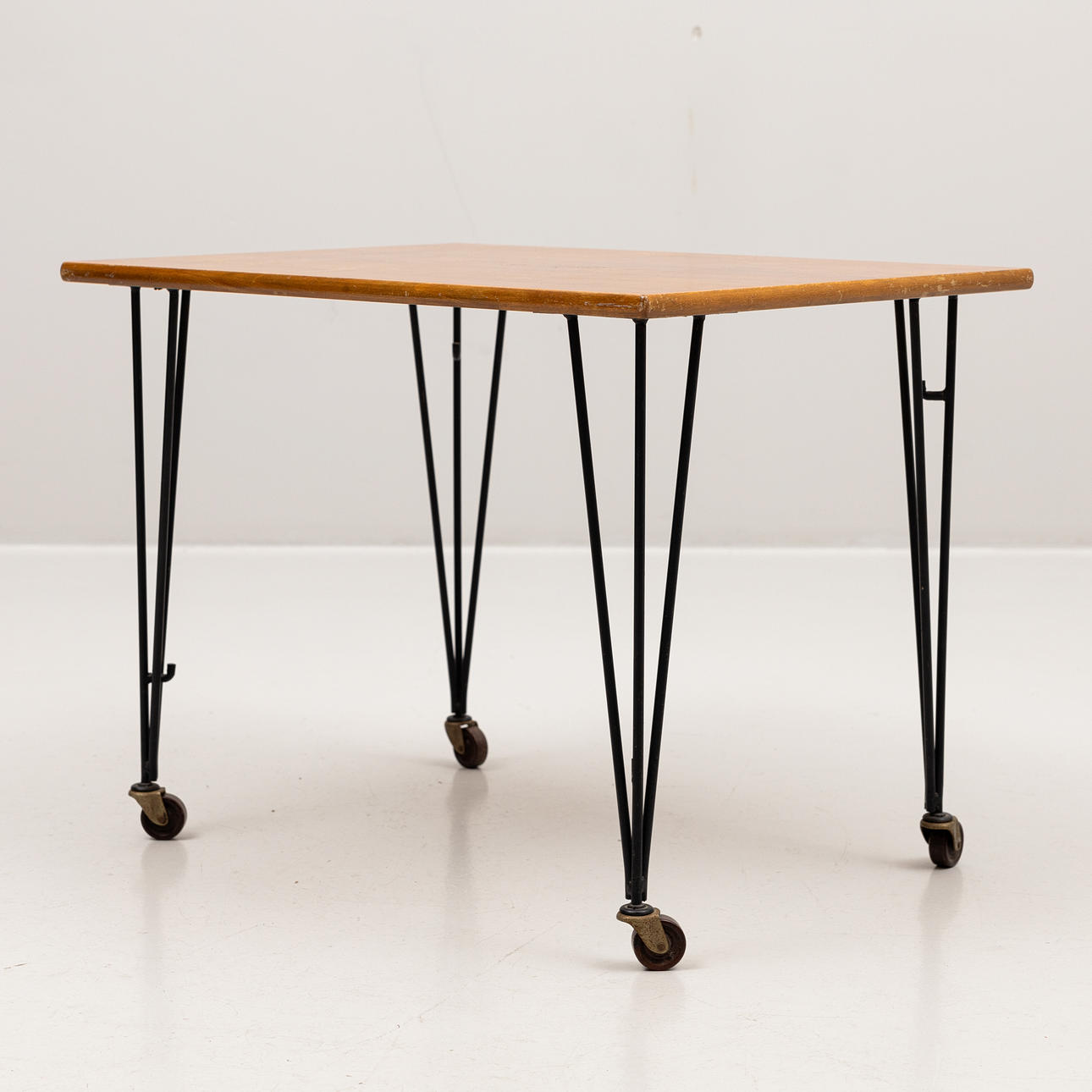 A mid 20th century teak and black-lacquered metal string table on ...