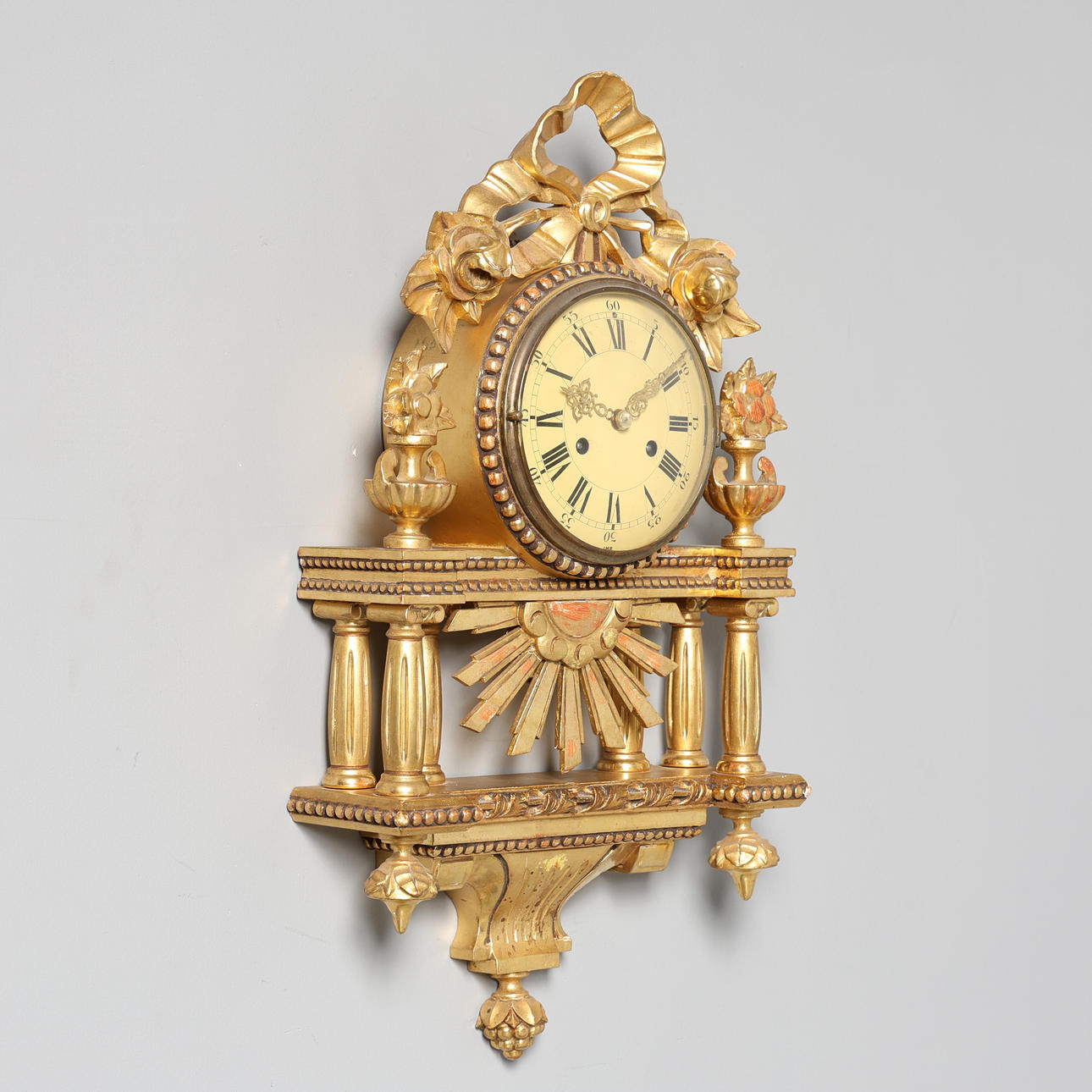 A Gustavian style wall clock, gilt.