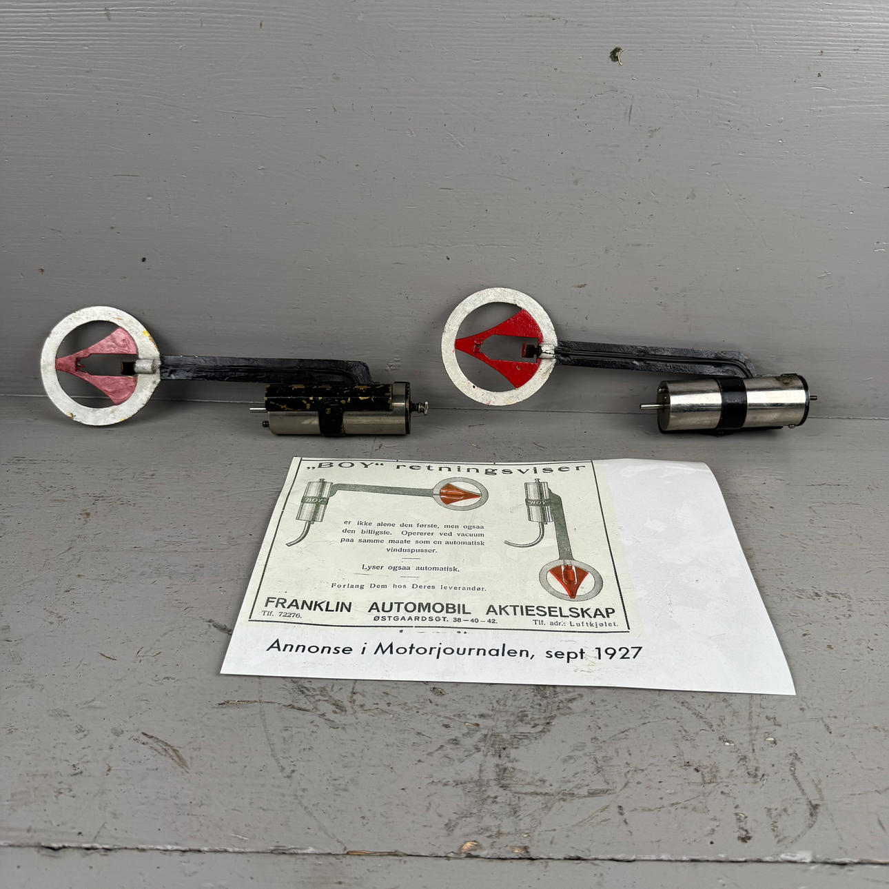 A pair of 1920s “BOY” direction indicators.