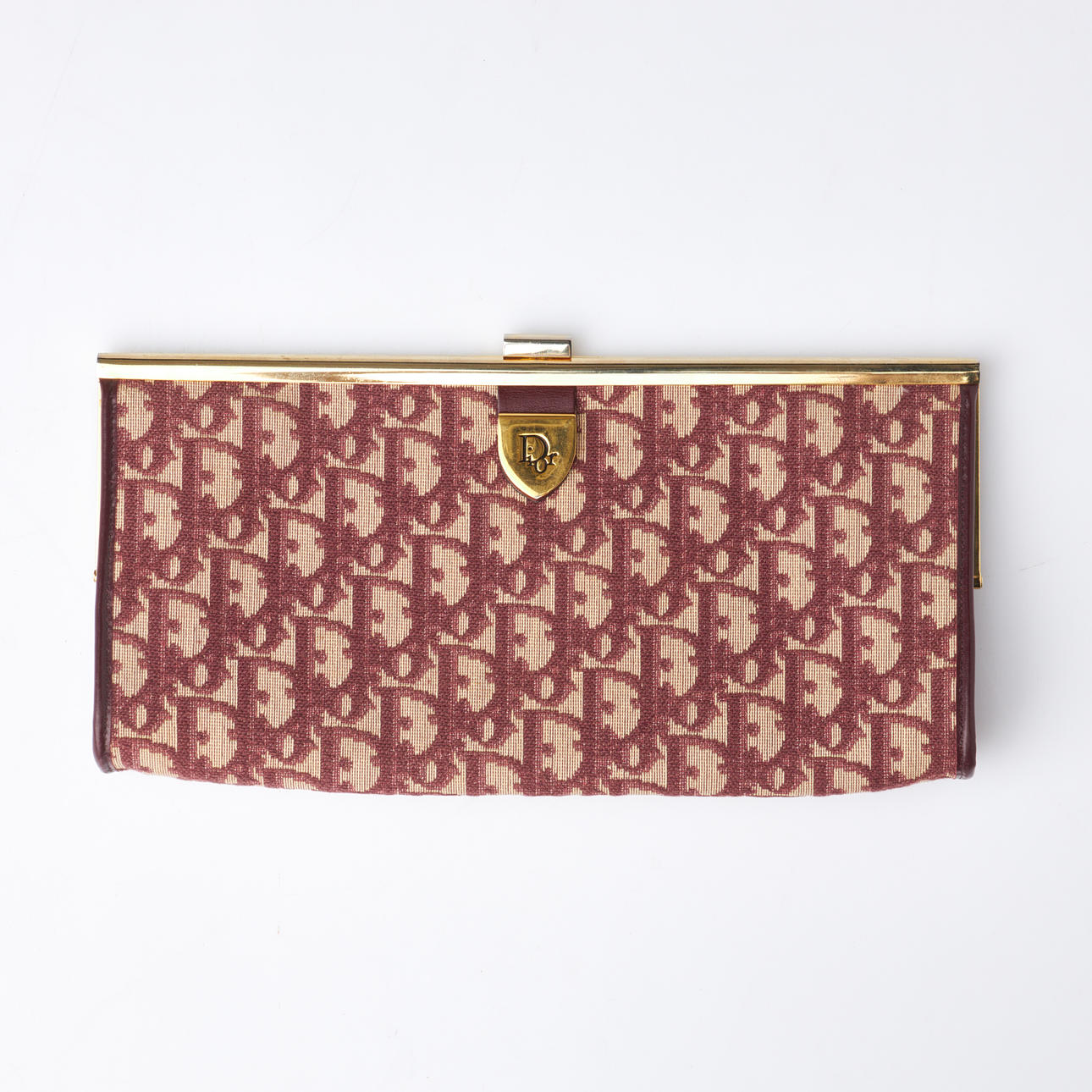 CHRISTIAN DIOR. Envelope bag, monogram patterned textile, yellow metal, leather.