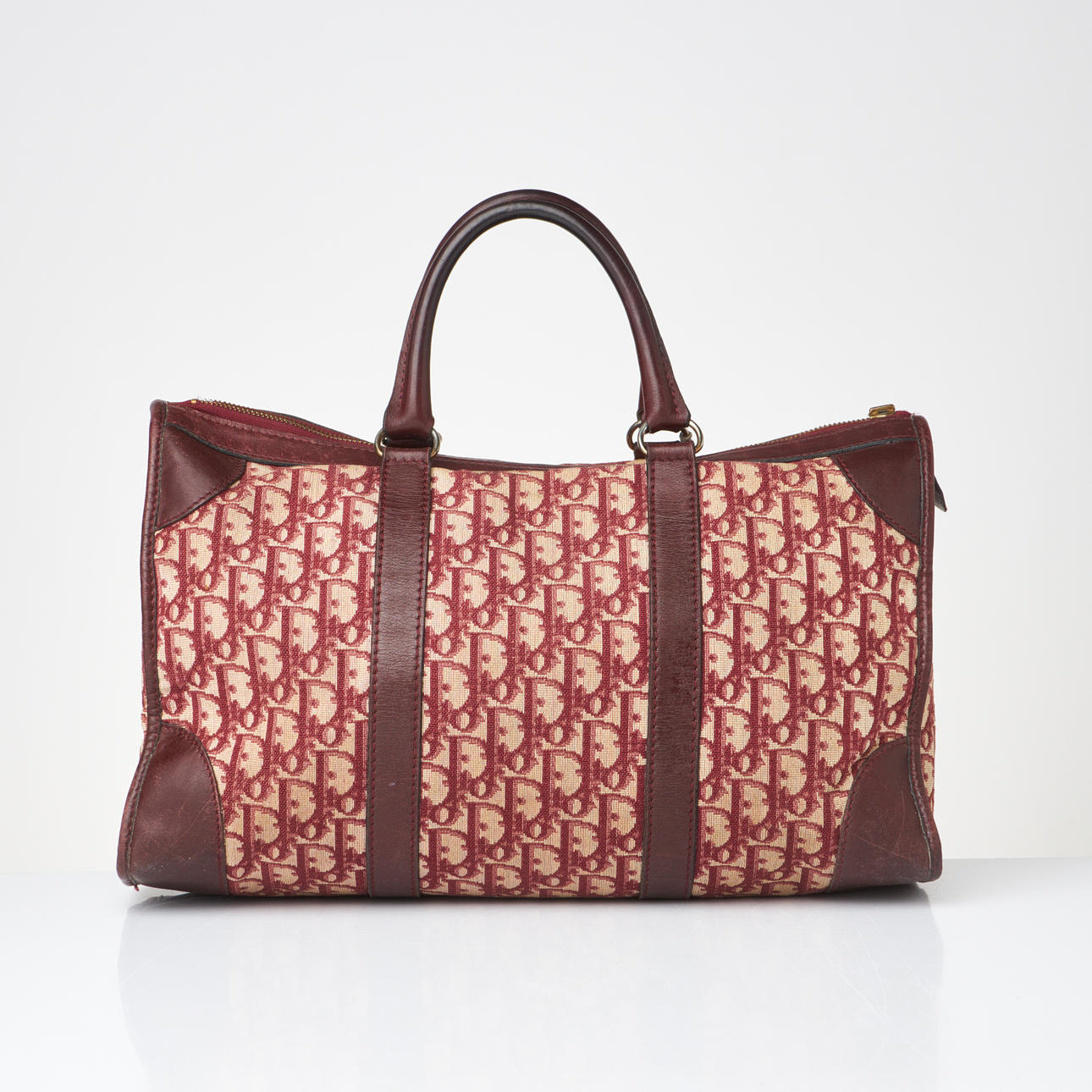 CHRISTIAN DIOR. Bag, monogram patterned textile, leather, inside with a compartment, label Christian Dior Bagages France.