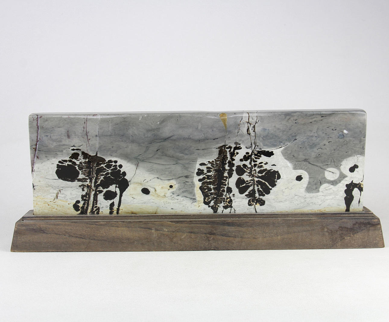 CHINESE POLISHED 'DREAM STONE' ON A WOODEN BASE.