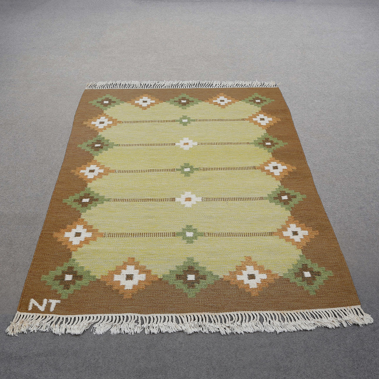 YARROW CUFF RUG, SIGNED NT.