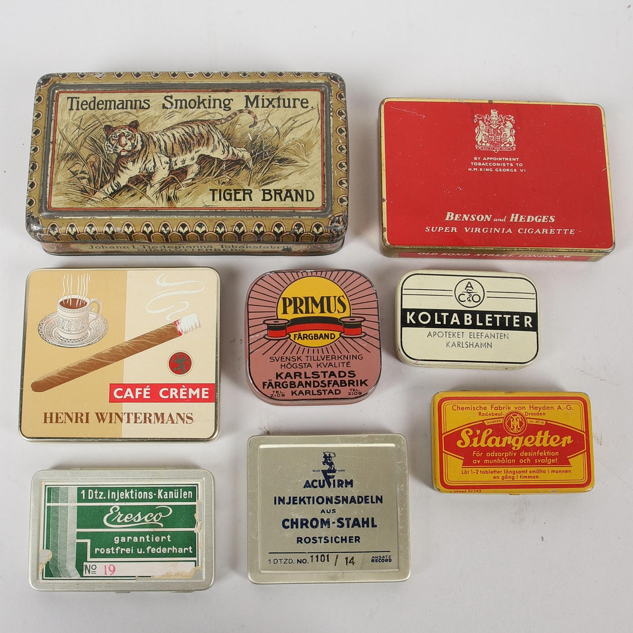 A set of 8 tin cans, including Tiedemanns Smoking Mixture Tiger Brand,  Charlottenberg, 20th century. Silver & Metals - Other metals