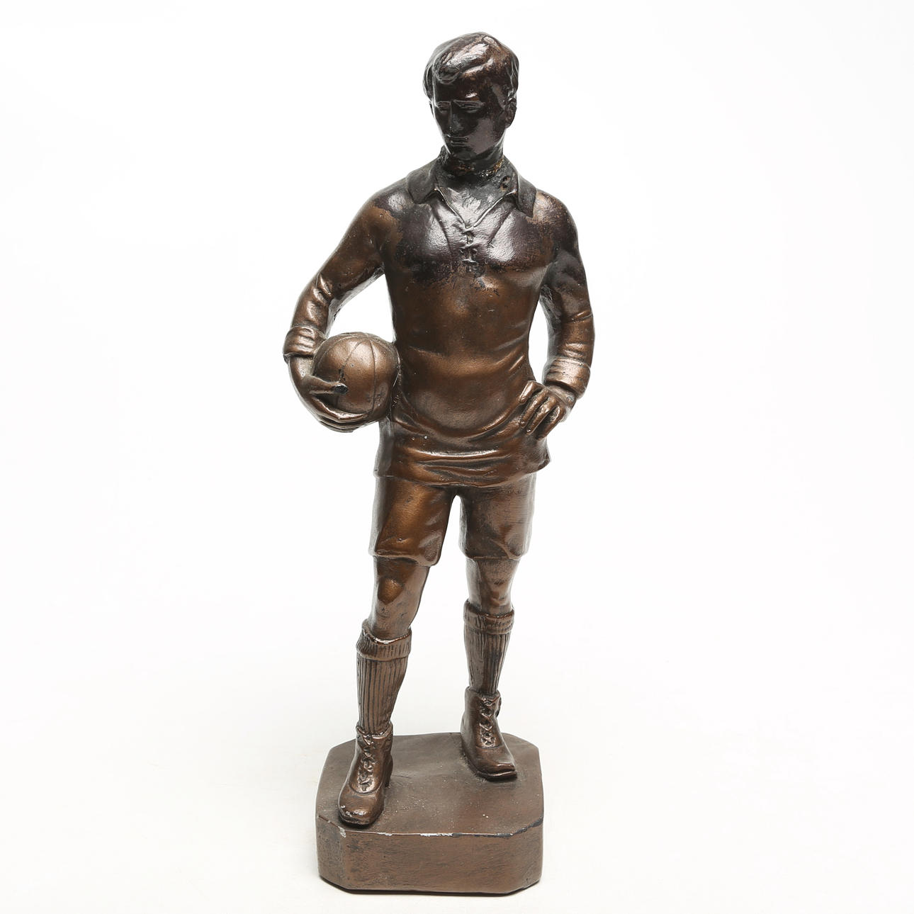A SCULPTURE, painted plaster, football player.