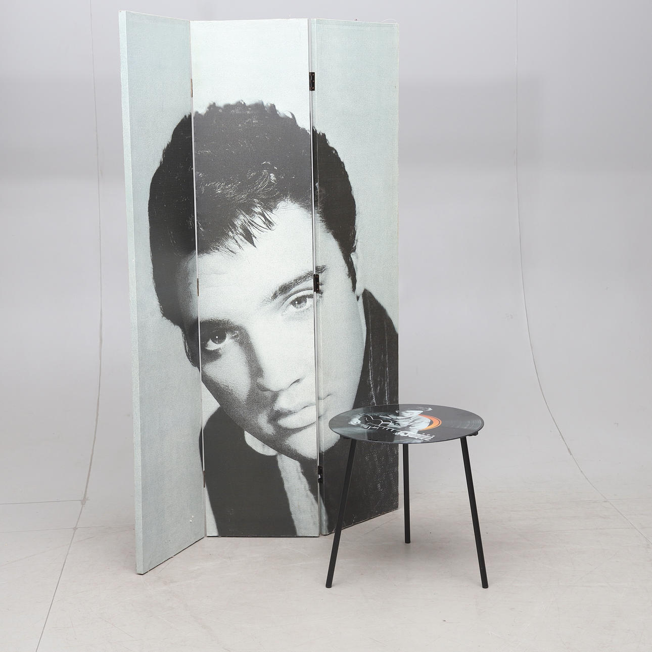 A folding screen and a table, 2000's. Elvis decor, 21st century.