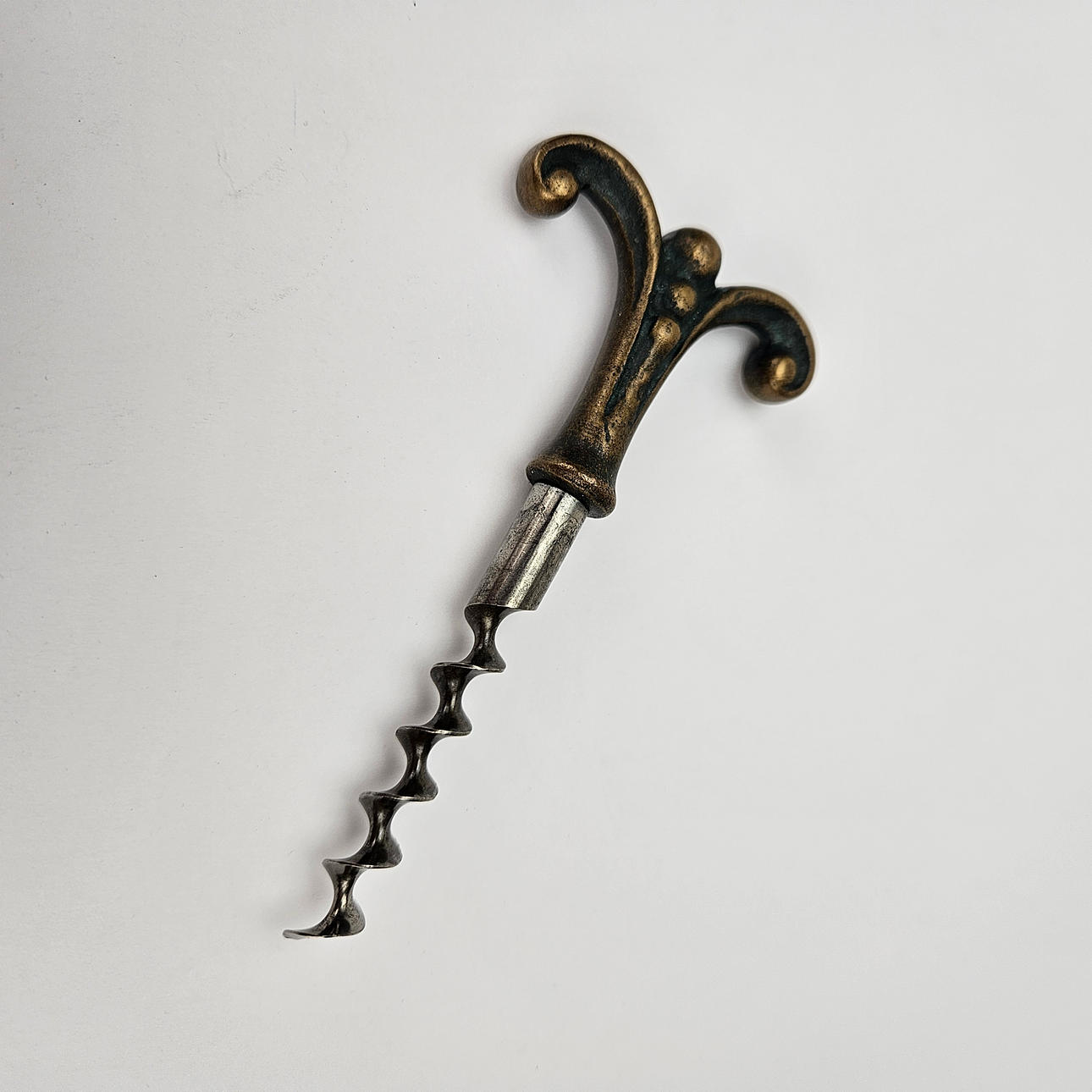 A metal corkscrew, marked CVH, first half of the 20th century. Silver ...
