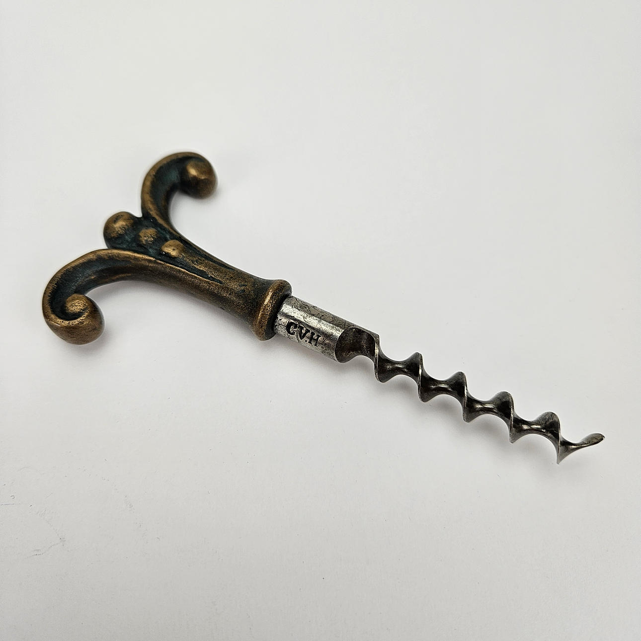 A metal corkscrew, marked CVH, first half of the 20th century. Silver ...