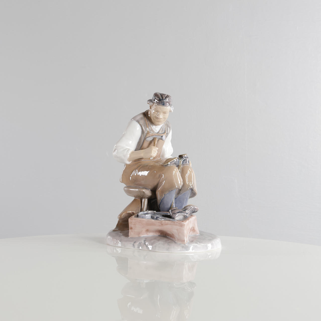 AXEL LOCHER. Porcelain figurine in the form of cobbler. Manufactured at ...