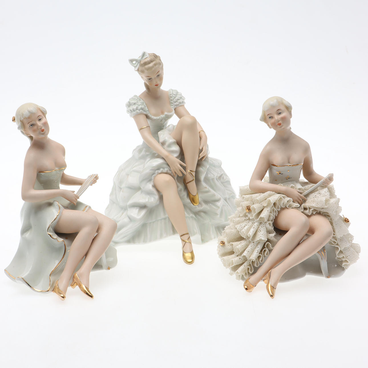 Three seated dancer figurines, Carl Scheidig & Wallendorf, Germany.