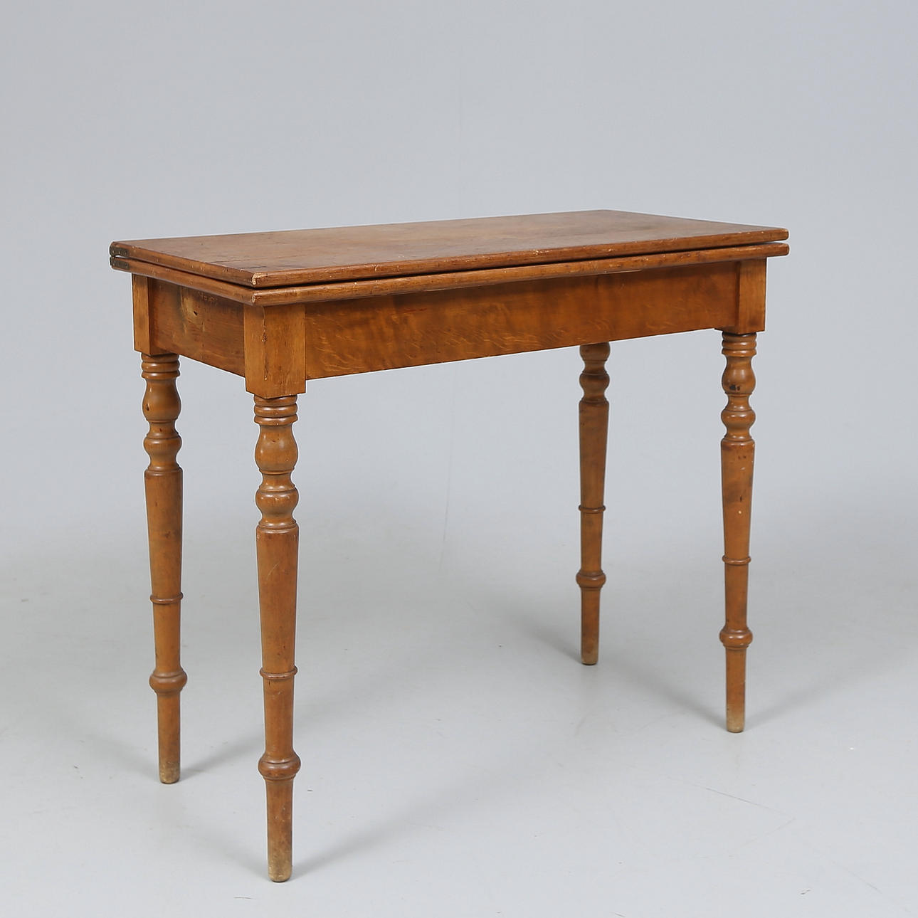 A 19th century gaming table with playing pieces.