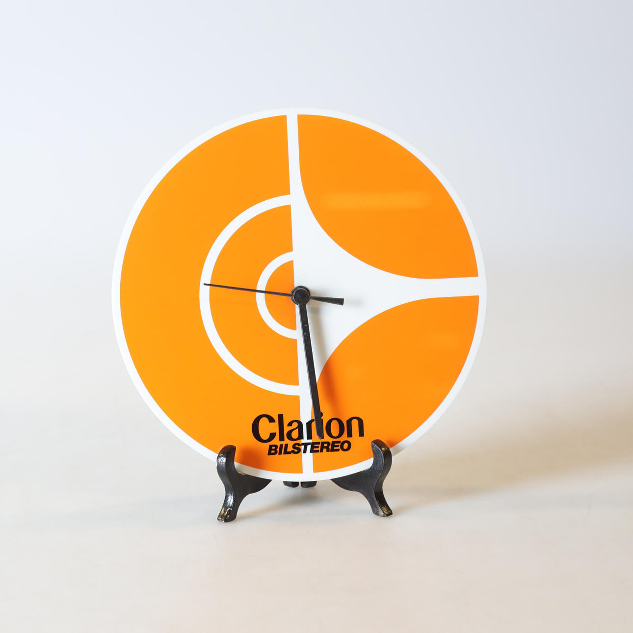 Wall clock, plastic, Clarion Car stereo.