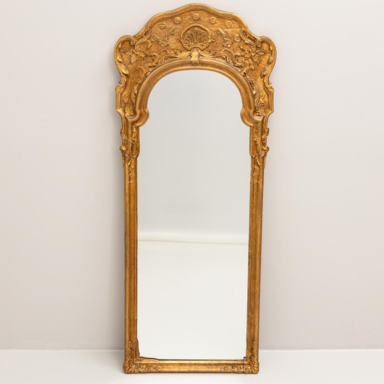 A 18th-century Rococo bronzed wood mirror.