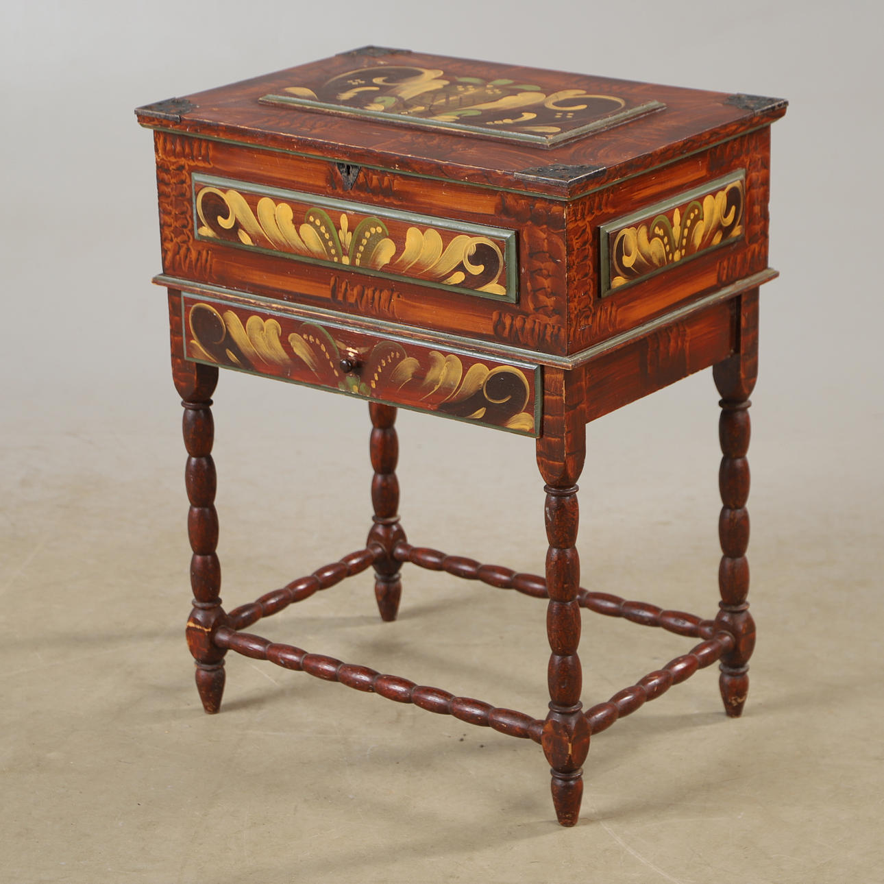 A mid-20th century kurbit-painted sewing table.