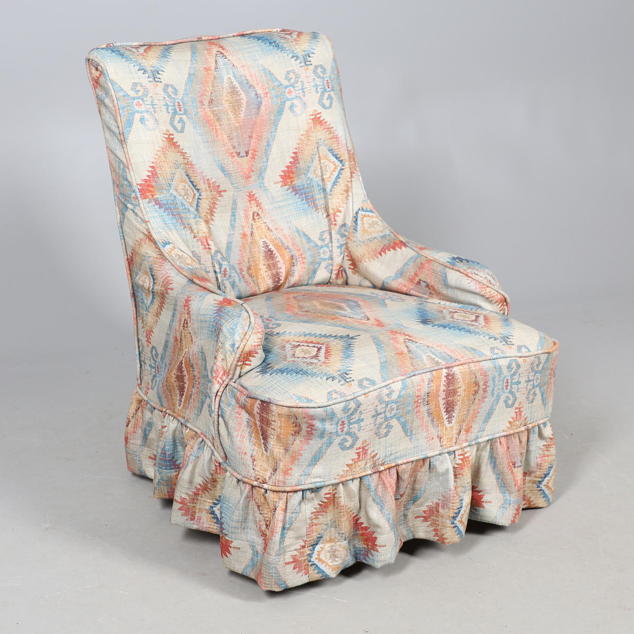 A VICTORIAN EBONISED ARMCHAIR WITH LOOSE COVER.